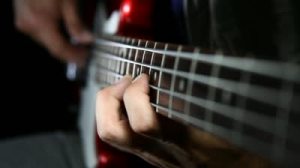 stock-footage-bass-guitar-player-close-up-playing-virtuoso-bass-with-fingers